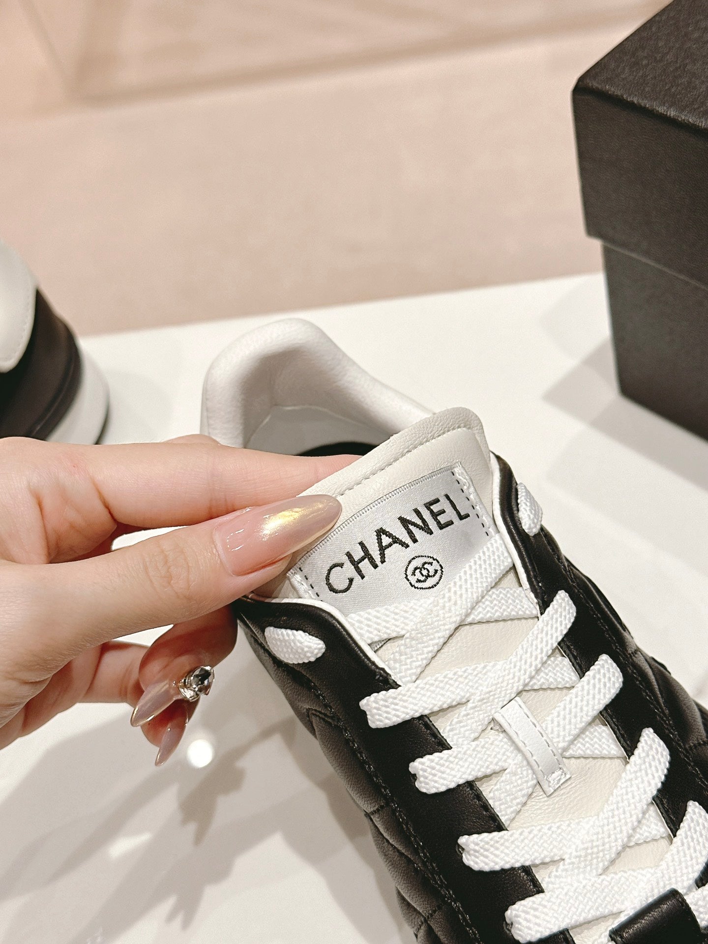 CHANEL SNEAKERS IN GLOSSY BLACK LAMBSKIN